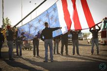 Firefighters preparing to raise the American flag. Firefighters preparing to raise the American flag.